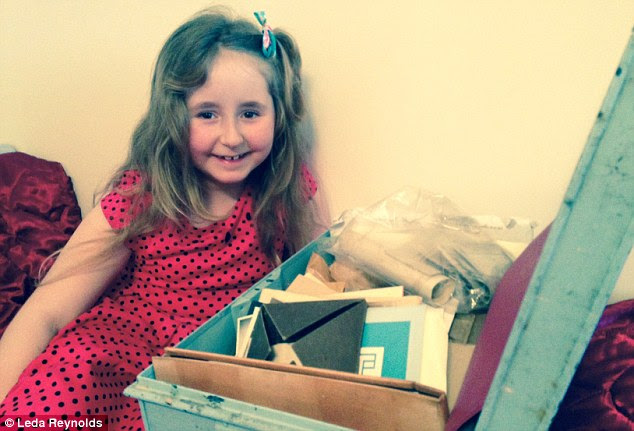 Leda's six-year-old daughter Verity peers into the battered tin trunk, which once belonged to her great-great grandmother, Esther Reynolds