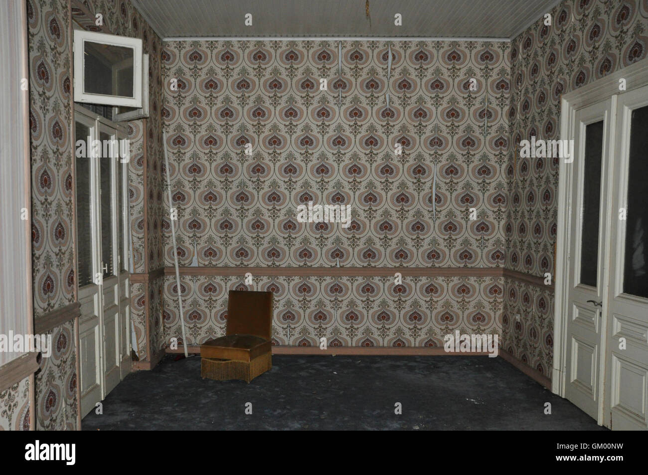 Vintage Chair And Wall With Retro Wallpaper Pattern In Empty