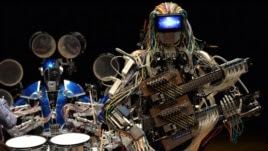 Robot guitarist "Mach" and robot drummer "Ashura" (L), members of a robot rock band "Z-Machines", perform music during the two day art and technology event "Maker Faire Tokyo."