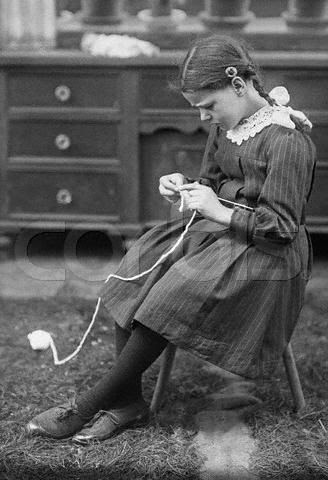 Little girl knitting.
