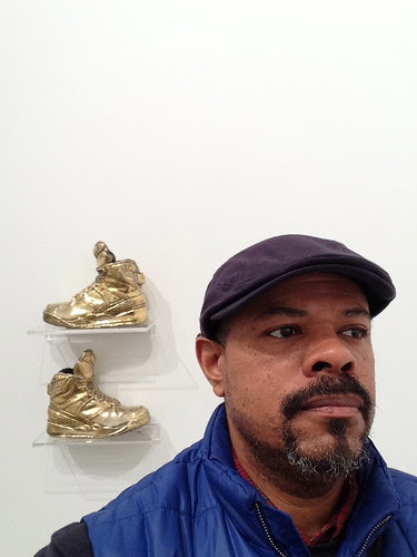 Self-portrait in front Gary Simmons' artwork
