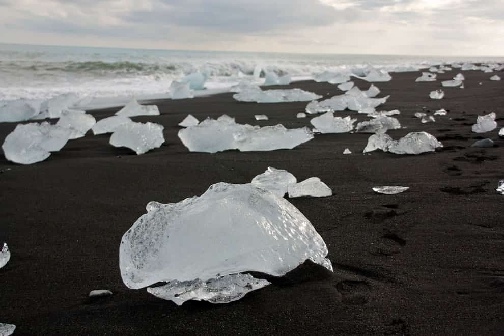 Icebergs from the Jökulsárlón glacier lagoon wash ashore, black sand beach in Iceland