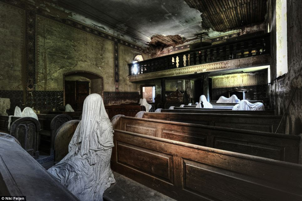Ghostly: This eerie photograph captures the dusty pews and peeling walls inside a boarded up church