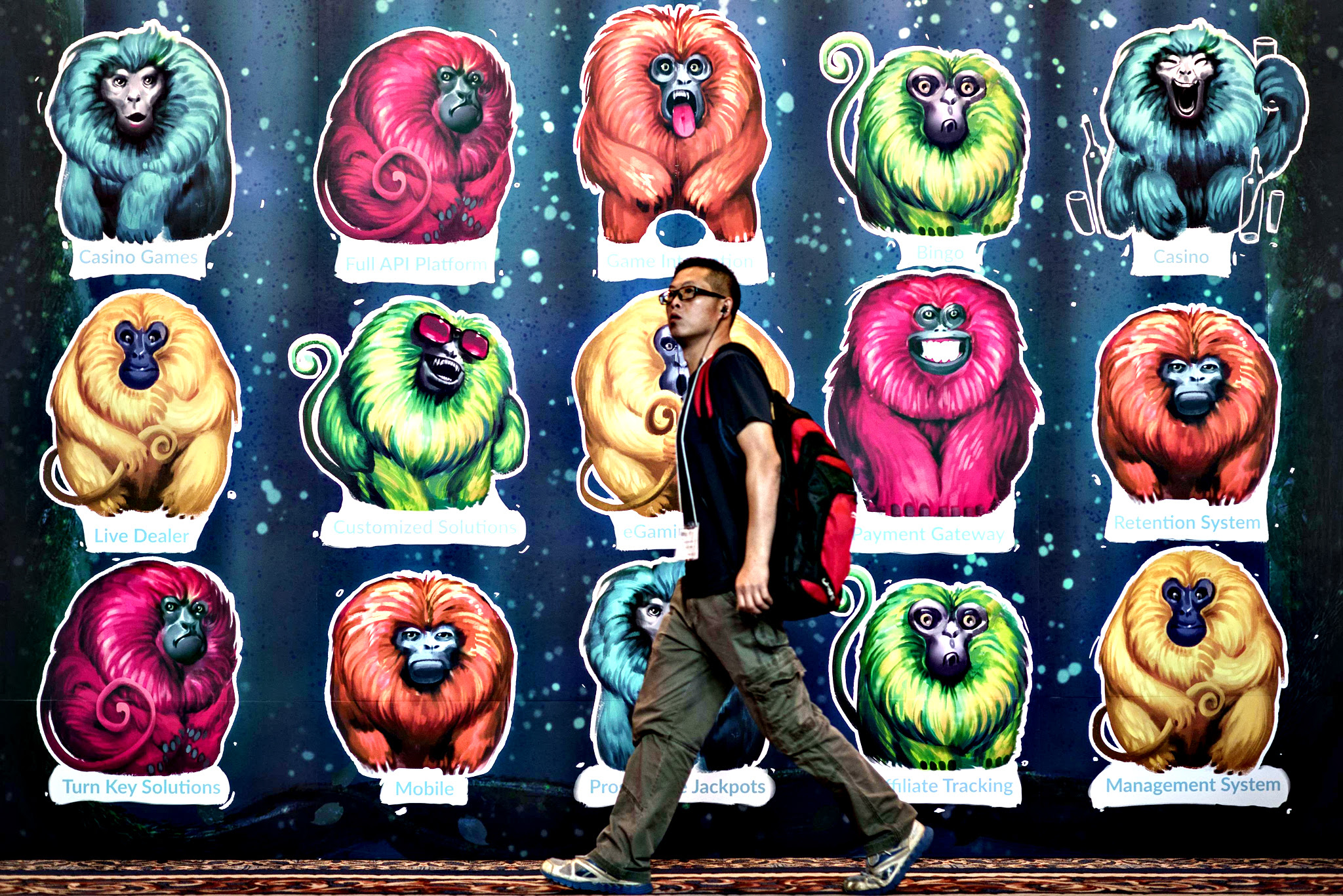 A man walks past a billboard at the Global Gaming Expo Asia in the world's biggest gambling hub of Macau on May 20, 2015. The three-day fair of gambling innovations, the largest gaming event in Asia, showcases the industry's latest products, services and technologies at the glitzy Venetian Macau hotel
