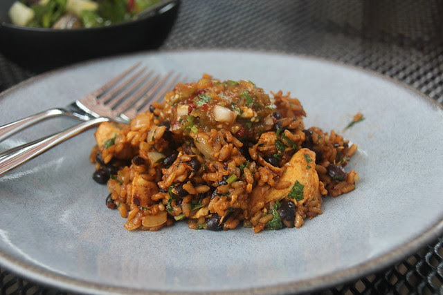 Red chile chicken with rice and black beans topped with smokey chipotle salsa