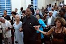 U.S. civil rights activist Jesse Jackson holds hands with believers during a religious service at the Martin Luther King Baptist congregation in Havana