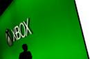 A man walks past the Microsoft booth at the Electronic Entertainment Expo on Thursday, June 12, 2014, in Los Angeles. (AP Photo/Jae C. Hong)