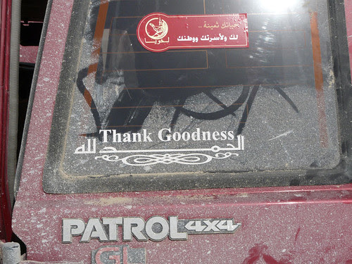 A Thank Goodness sign on the back of the car