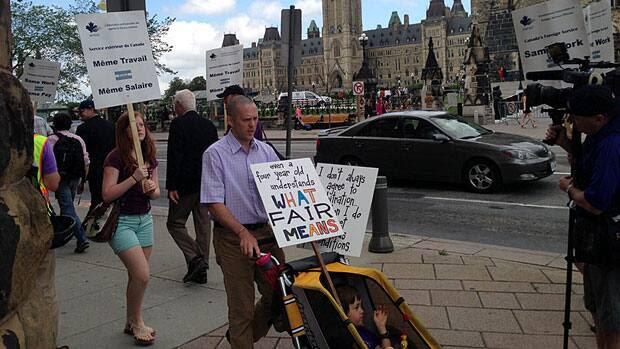 Foreign service officers who are on strike demonstrate outside Prime Minister Stephen Harper's office in Ottawa on Tuesday.