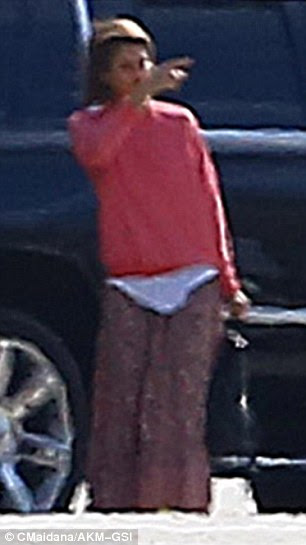 Comfy casual: The Sin City actress was dressed comfortably in a pink pullover and patterned maxi dress