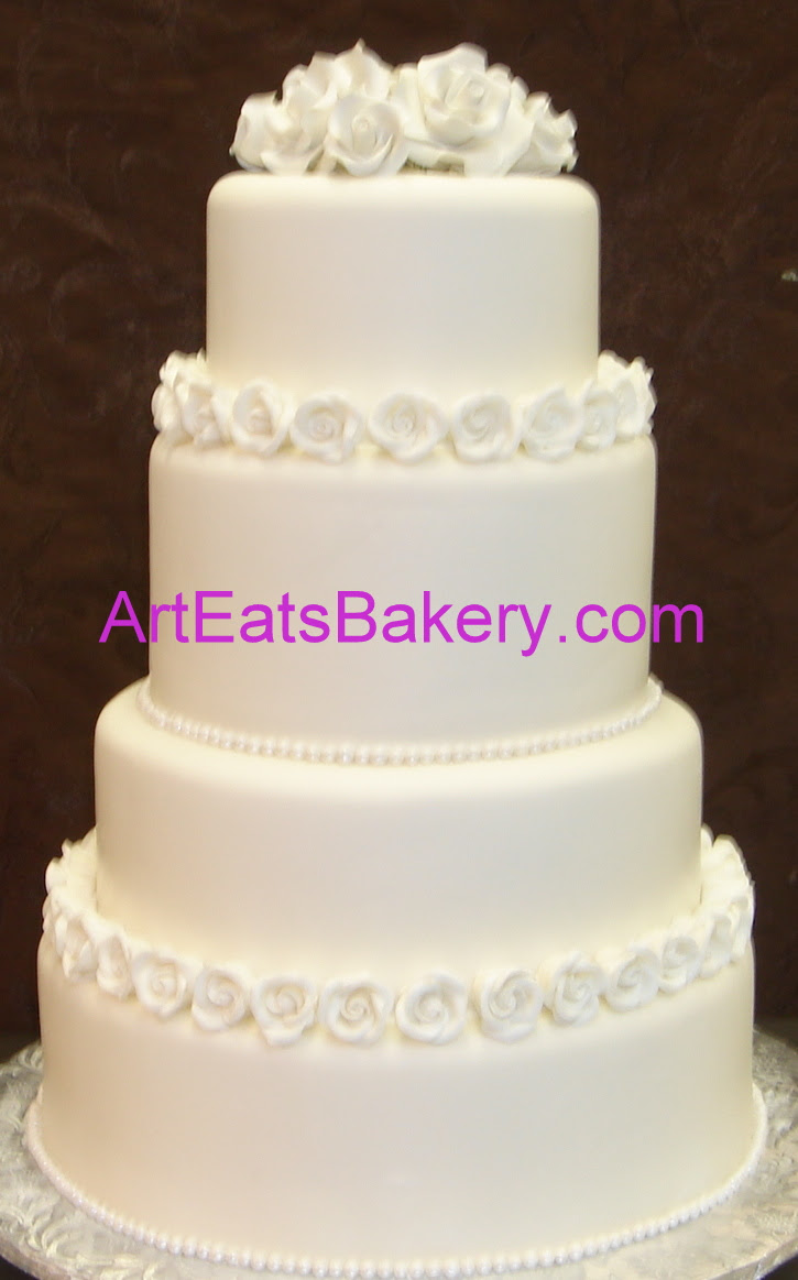 Four tier round classic wedding cake design with white sugar roses and pearls.jpg