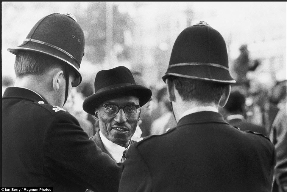 A man speaks to a pair of police constables at Speakers Corner, Hyde Park