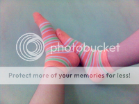 feet in colorful socks, against the wall 2005