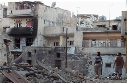 Men walk past destruction in Bab-Todmor in Homs