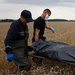 Emergency workers on Saturday carried a body from the site of the Malaysia Airlines Flight 17 crash in the Donetsk region. For many, the disaster brought home a struggle that had seemed distant.