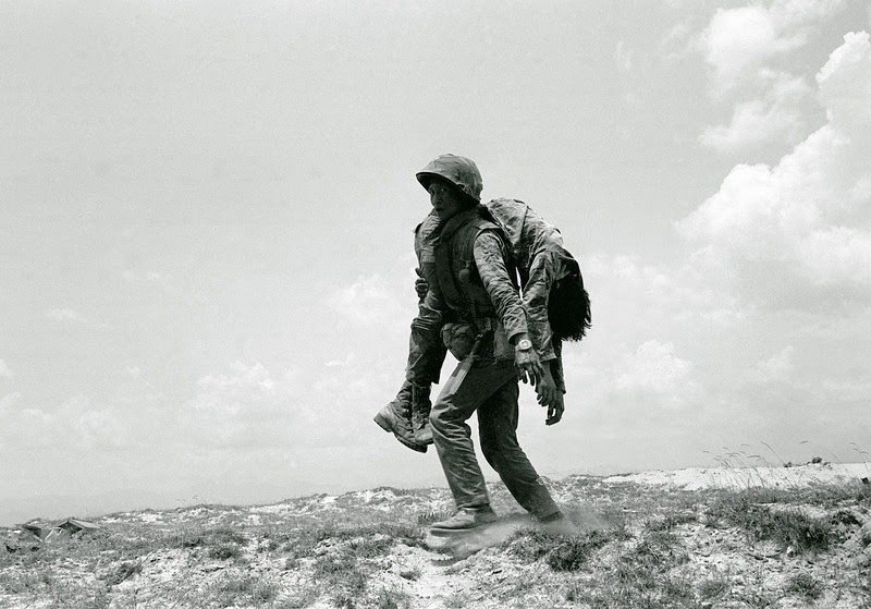 Description of  A South Vietnamese Marine carries the dead body of a comrade killed on Route 1, about seven miles south of Quang Tri Sunday, April 30, 1972. Marines were fighting to reopen the road in order to break the North Vietnamese siege of the provincial capital. (AP Photo/Koichiro Morita)