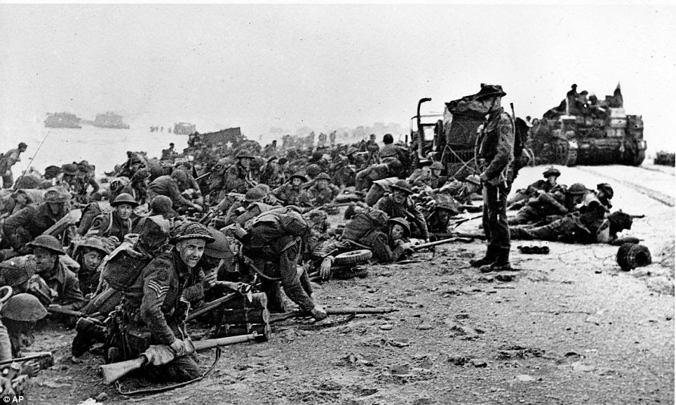 Only the brave: After landing at the shore at Normandy, these British troops wait for the signal to move forward into the French countryside