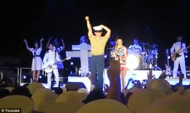 Achievement: The 20-year-old man fist-pumped the air after he locked lips with the mega star