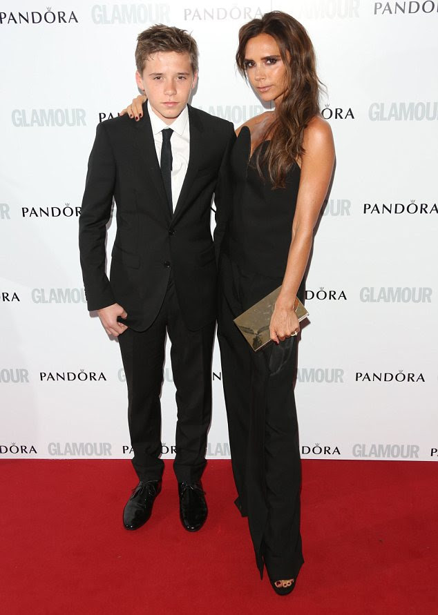 All grown up: Victoria Beckham arrived on the red carpet with her eldest son Brooklyn in tow and the 14-year-old looked dapper in a smart suit and tie 