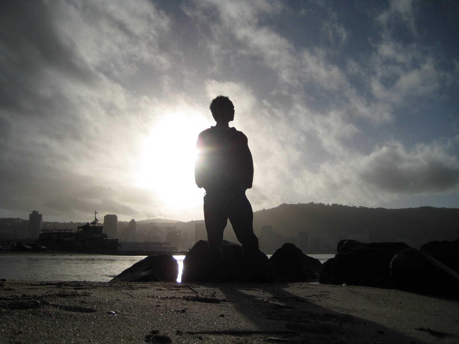 Free Photo of Silhouette of Man Standing on Beach Against ...