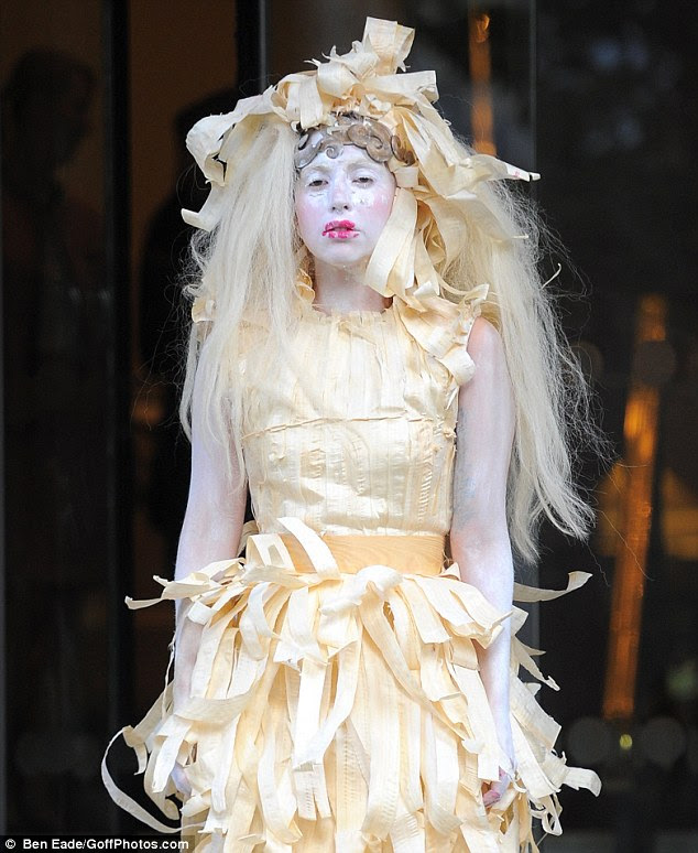 Quite an exit: The outlandish singer catches the eye courtesy of another bizarre outfit