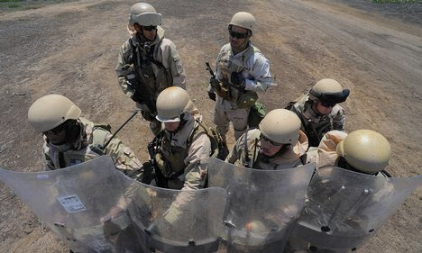his riot shield during an
