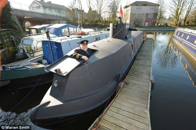 The mock U-8047 u-boat stands out alongside the other canal boats in ...