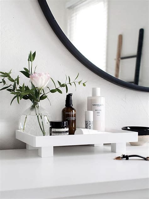 Considering adding an open shelf bathroom vanity to your space? Bathroom Vanity Tray Ideas For Organizing In A Sleek Way