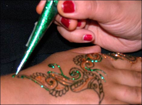 Mad About Music photo gallery image. Having a sparkly henna tattoo applied 