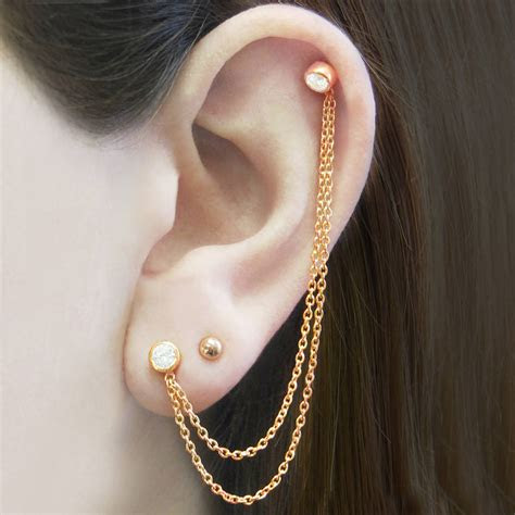 Whether you're just getting on the rose gold train or are a longtime pinkish metal obsessive, we've rounded up 14 pieces any jewelry fiend will love. rose gold chain topaz birthstone earrings by embers