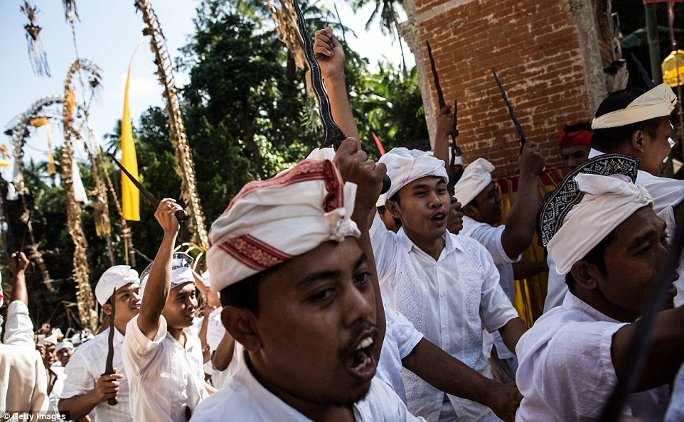 Clad in white and each holding 'keris' daggers, men arrived at Puseh Temple to honour their ancesters and God with the sacred ritual on September 11