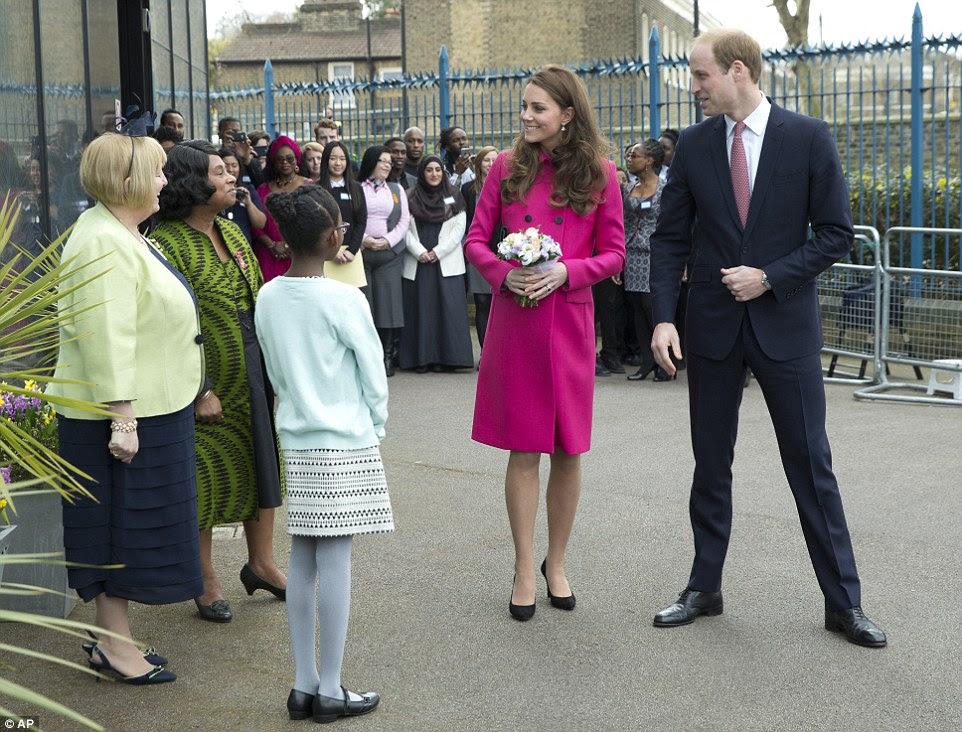 Well-wishers snap away on their mobile phones as they catch a glipmse of the royal couple leaving the centre