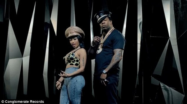 Curvy and proud: Nicki squeezed into skintight high-waisted jeans and an animal print bustier for the video 