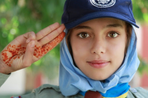An Afghan scout salutes visitors at Red Crescent Society Compound in Kabul