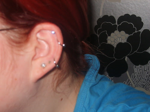 and two cartilage piercings in