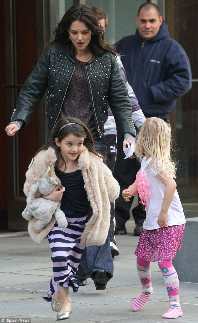 Busy mother: Katie was awarded sole custody of the former couple's daughter Suri, who she lives with in New York and is often seen out and about with the tot