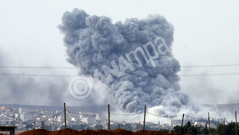 epa04442843  A view from Turkish territory showing smoke rising after an airstrike hit Kobane, Syria, by alleged alliance war plane during an armed clashes between YPG Kurdish fighters and Islamic State in Kobane, Syria, near Suruc district, Sanliurfa, Turkey, 12 October 2014. The Islamic State militant group captured a security compound near the centre of the Syrian Kurdish enclave of Kobane and targeted the border crossing with Turkey, a monitoring group said. The militants have gained control of 40 per cent of the town in street-to-street fighting with its hard-pressed Kurdish defenders, the Syrian Observatory for Human Rights said.  EPA/TOLGA BOZOGLU