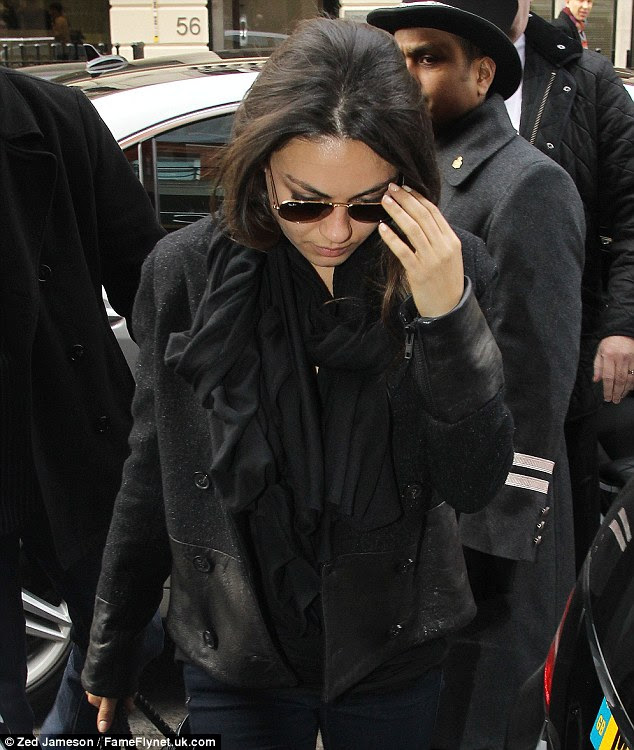 Star style: Mila kept her eyes shielded from the paparazzi's flashes with a pair of Ray Ban sunglasses