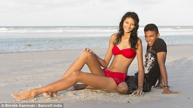 Loved up: At 6ft 8in-tall, Elisany towers over her smitten partner, who is just 5ft 4in