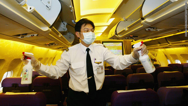 A flight attendant sprays disinfectant onboard a Thai Airlines flight to Chiang Mai from Bangkok.