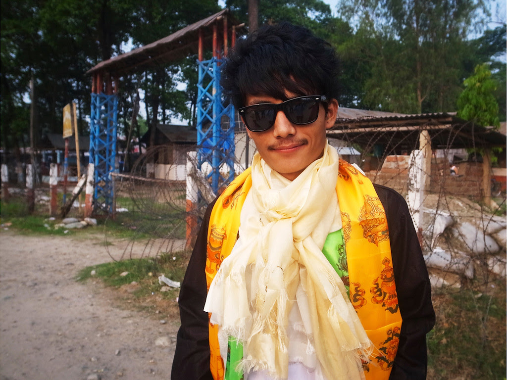 Description of . “We put a ceremonial scarf called a khada over the shoulders of the relatives and friends who are departing as a sign of respect and remembrance.”   - Mani Kumar