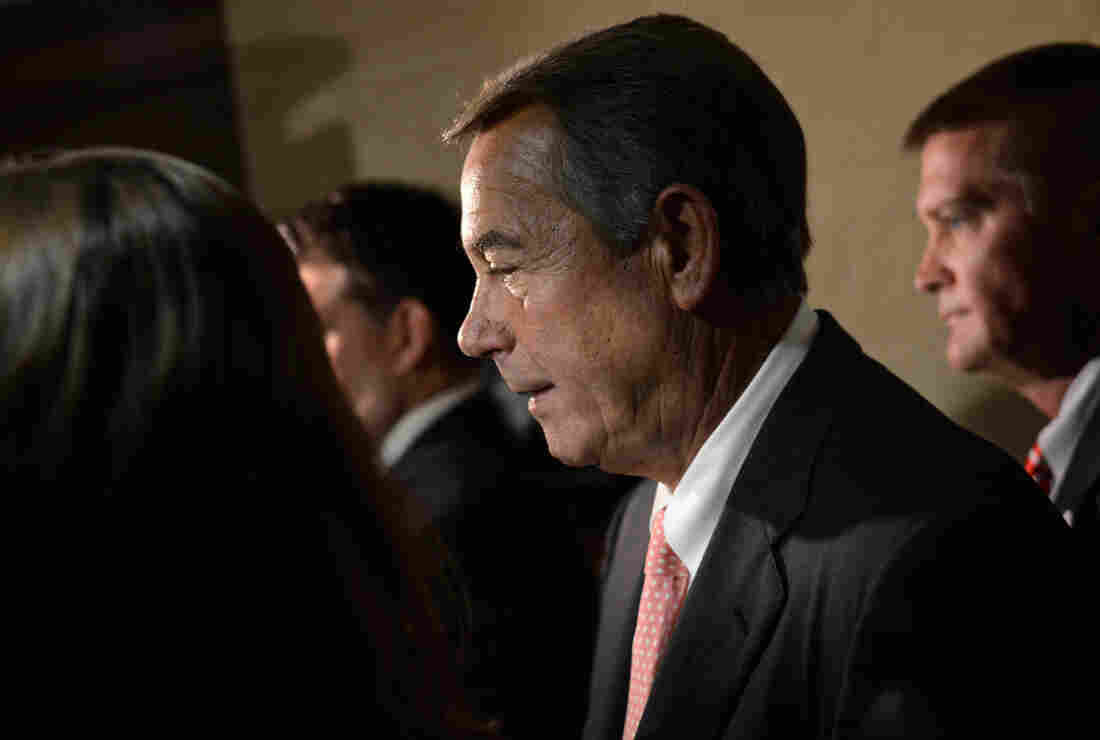 House Speaker John Boehner exits a Republican caucus meeting in the U.S. Capitol on Friday after announcing to the meeting that he will be resigning his speakership and his seat in Congress.
