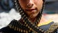 A Palestinian youth wraps a bandolier of spent bullets, left by the Israeli army near his destroyed home in Beit Hanoun, Gaza Strip.