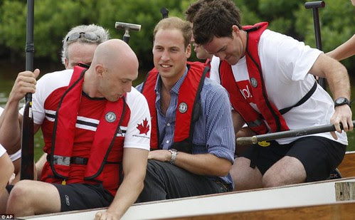 Prince William rules the waves as he beats Duchess of Cambridge in dragon boat race but despite the drizzly day Kate Middleton looks simply 29