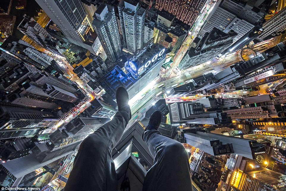 Impressive: Mr Kuznetsov says he likes to take photographs his feet hanging over the edge of a roof (as in this image and the two below, all taken in Hong Kong) as they demand more from him and are 'quite showy'