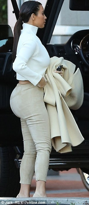 Accentuating her curves! Kim Kardashian stepped out in a pair of VERY tight-fitting cream trousers in LA on Monday