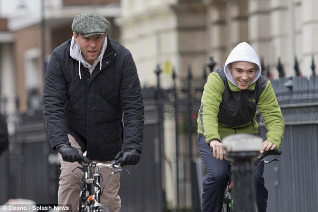 Happy: Last week, Rocco was spotted out in London grinning broadly as he cycled with his dad