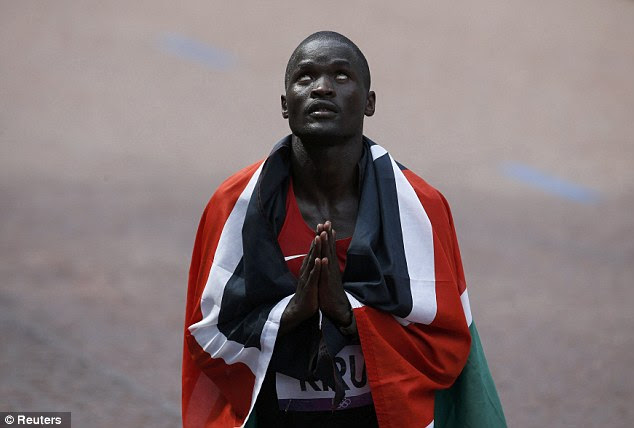 Silver service: Kenya's Kirui prays after coming second place