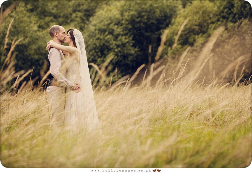 Bride kissing in wheat field