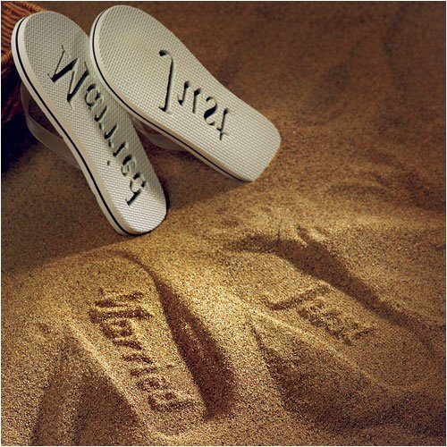 flip flops in the sand. These just married flip flops